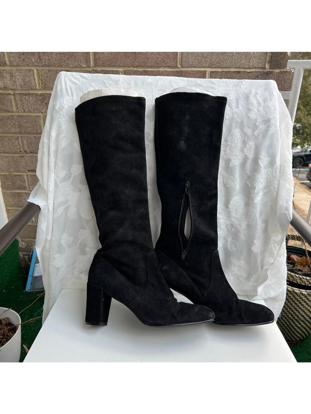 Black suede knee high boots with a block heel